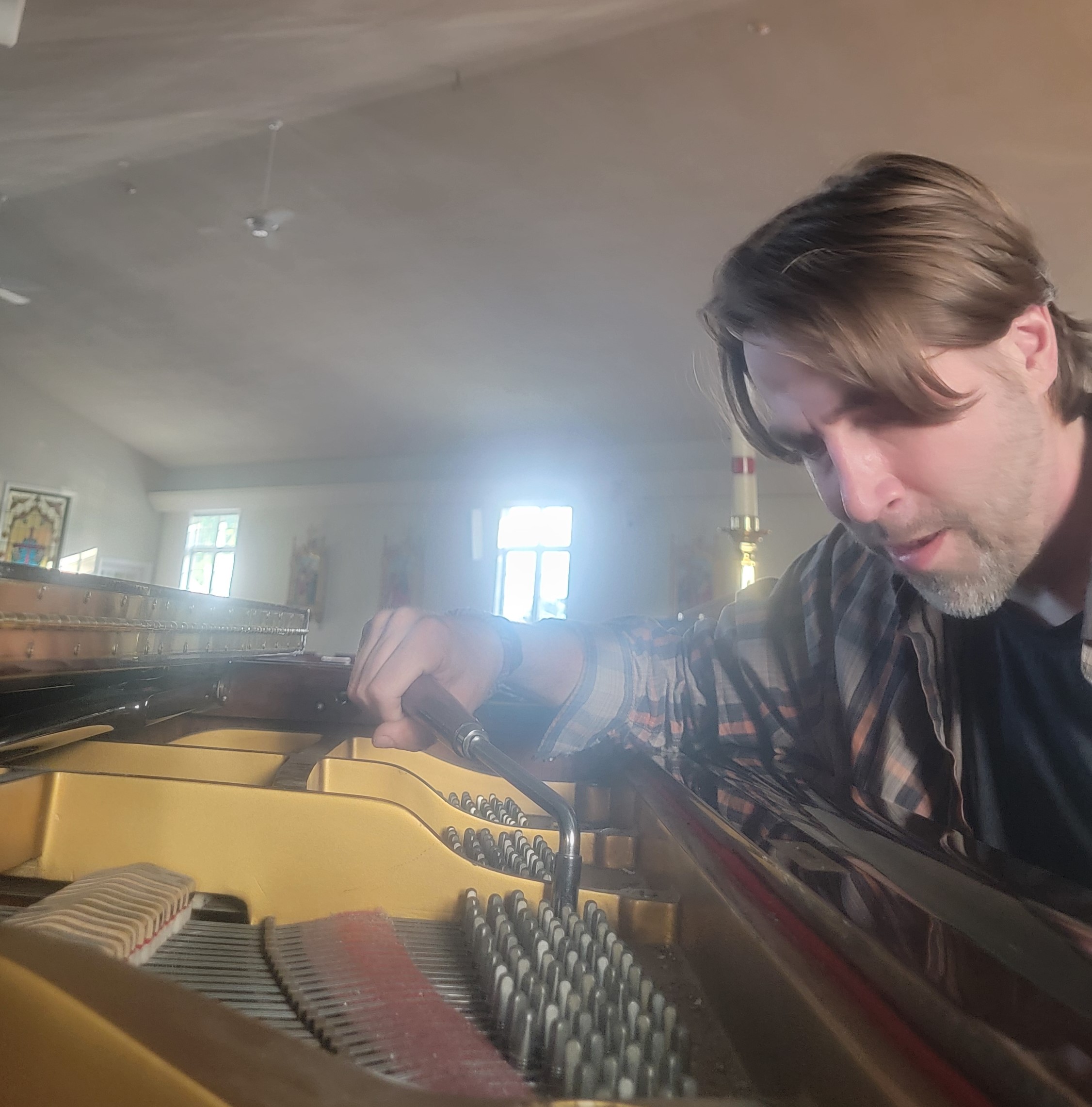 Michael Keating tuning a piano at St. Anne's